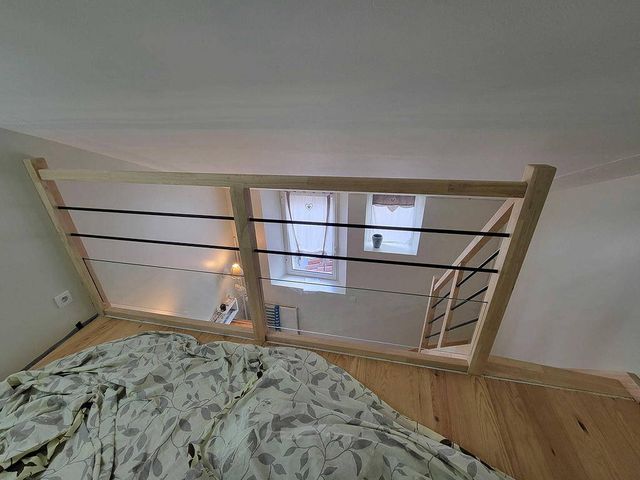 Mezzanine desservie par l'escalier, garde-corps bois et lisses métal, à Nantes